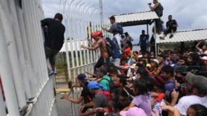 migrants force their way to Mexico