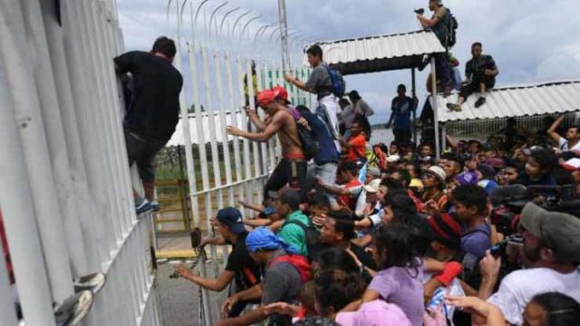 Migrants Break Border Gate, Force Their Way Into Mexico 