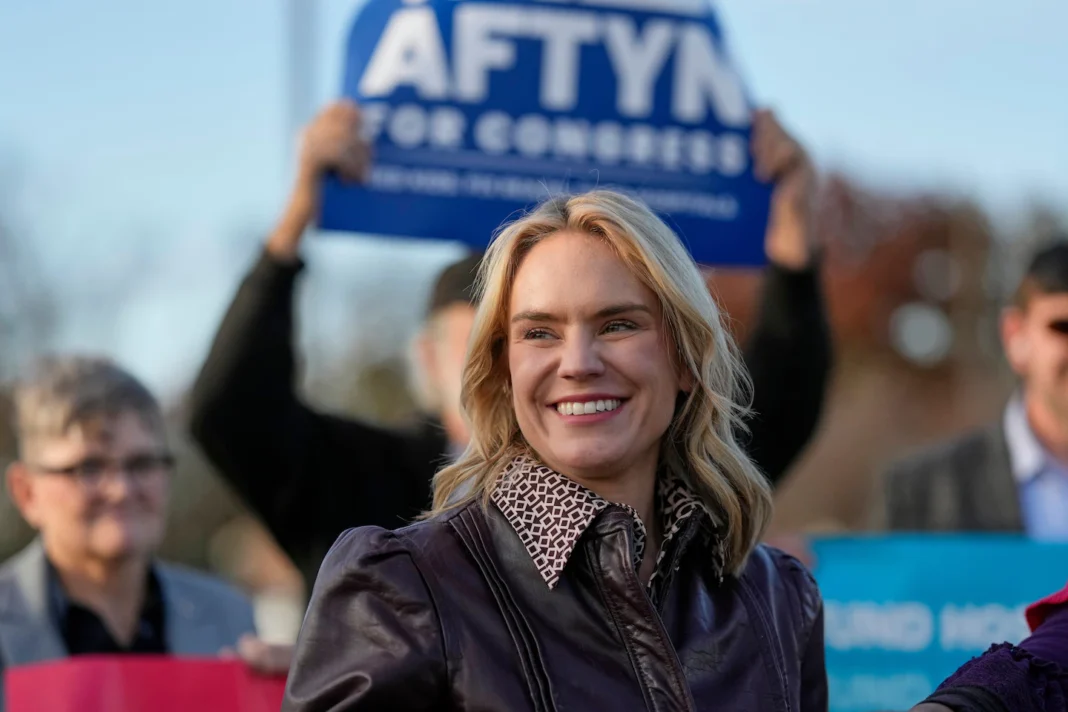 ‘AOC of Tennessee’ Under Fire After Resurfaced Clip Shows Her Saying She “Hates” Nashville A crowd gathers at a political rally, displaying signs supporting a congressional candidate. One speaker stands prominently in the foreground.