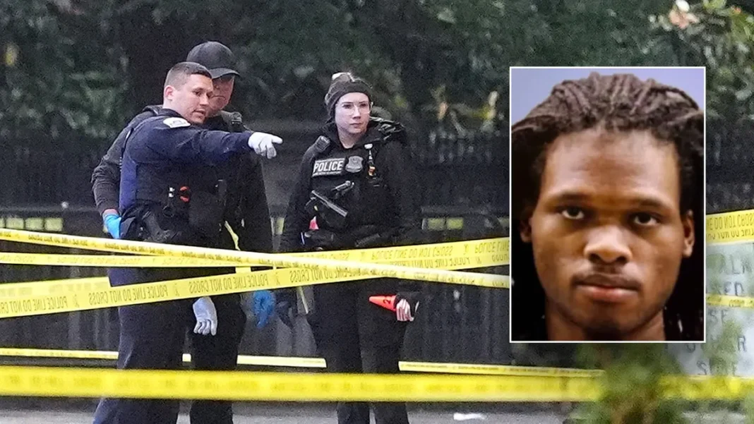 deadly-shooting-white-house-2026 Police officers stand behind yellow crime scene tape at an outdoor investigation site with an inset photo of a person.