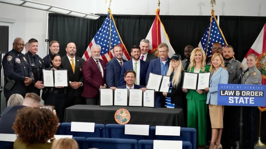 DeSantis Expands Protections for Florida Police With New Officer Safety Law Governor Ron DeSantis signs the Officer Jason Raynor Act during a public safety event in Winter Haven, Florida.