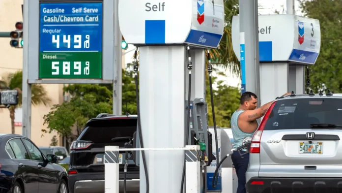 florida-gas-prices-fourth-july-travel-2026 Drivers fueling up at a Florida gas station ahead of the Fourth of July holiday