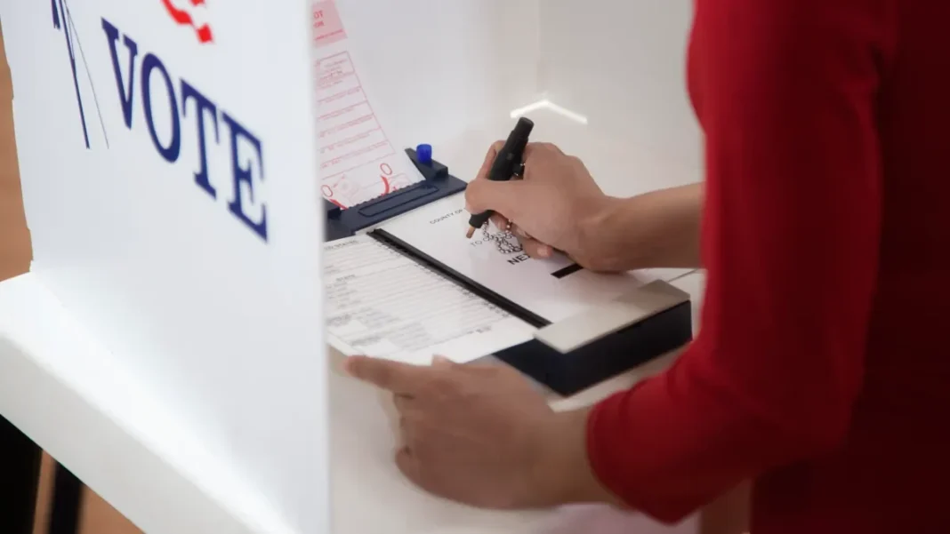 florida-voter-casts-ballot-primary-election-2026 A Florida voter marks a ballot inside a voting booth during the 2026 election.