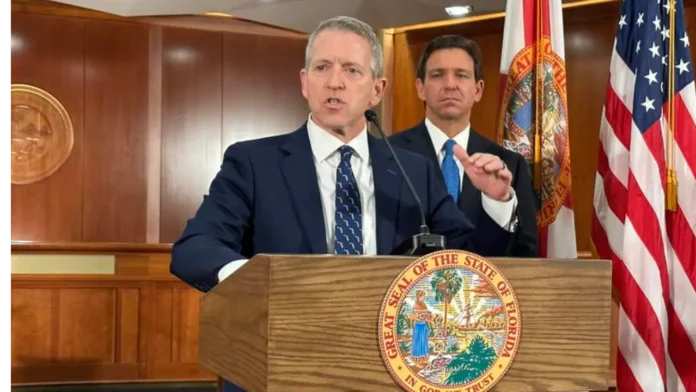 desantis-renner-florida-governor-race-2026 Former Florida House Speaker Paul Renner speaks at a podium while Gov. Ron DeSantis stands behind him during an official event in Florida.