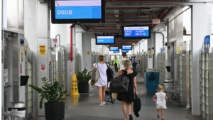 Passengers walk through a concourse at Miami International Airport in Miami-Dade County.